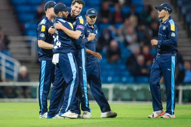 Azeem Rafiq hugs Matthew Fisher after Yorkshire wrapped up victory