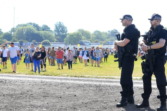 Armed police patrol the grounds of Burton Constable Hall in Hull where thousands of people are attending the Radio 1 Big Weekend.
