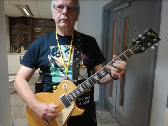 Ched Cheeseman with Mick Ronson's guitar