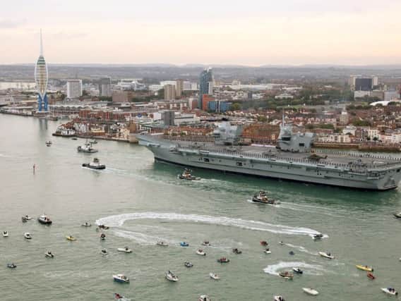 The HMS Queen Elizabeth, the UK's newest aircraft carrier, sails past the Spinnaker Tower as she arrives in Portsmouth this morning. Picture: LPhot Dan Rosenbaum/Royal Navy/PA Wire