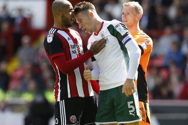 Angus MacDonald leans his head towards Leon Clarke before both are shown red cards (Photo: Sportimage)