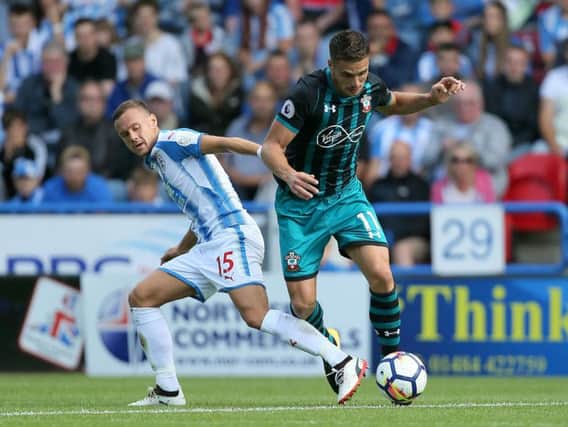 Dusan Tadic dances past the tackle of Huddersfield Town's Chris Lowe