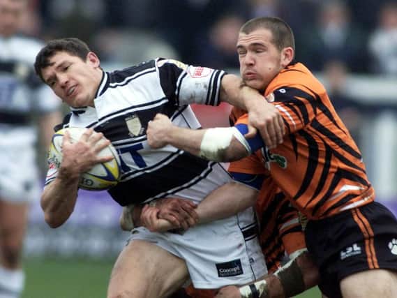 Hull FC's Adam Maher tries to shake off Castleford Tigers' Danny Orr.