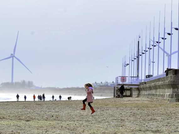 A young girl runs towards the North Sea at Bridlington South beach on a bracing day at the coast as people walked off the excesses of Christmas and the New Year celebrations. Gary Longbottom