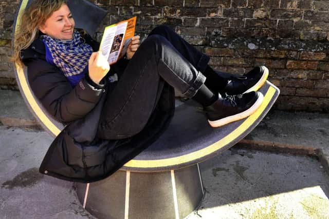 Artist Adele Howitt takes a break on the 'Elegance Bench'