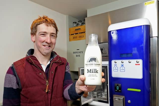 Aysgarth dairy farmer Ben Spence in a converted a horse box mobile shop containing a vending machine, from which customers can pour fresh whole milk into glass bottles.