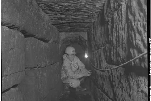 An archaeologist exploring the Roman Sewer beneath Church Street. Photo: York Archaeological Trust