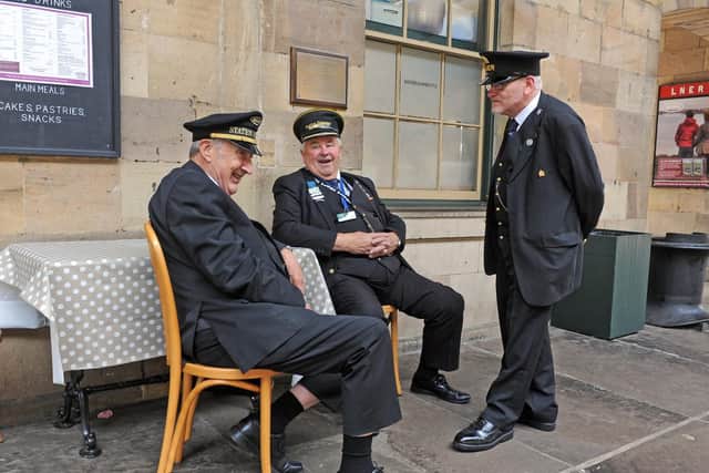Volunteers relax as they wait for a train at Pickering