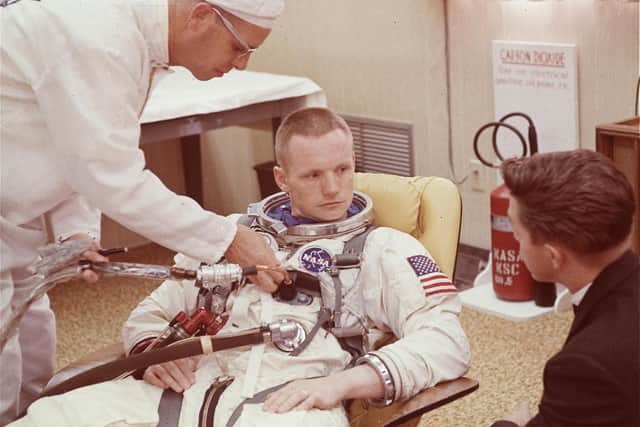 In this March 9, 1966 file photo, astronaut Neil Armstrong is seated during a suiting up exercise at Cape Kennedy in preparation for the Gemini 8 flight. AP Photo.