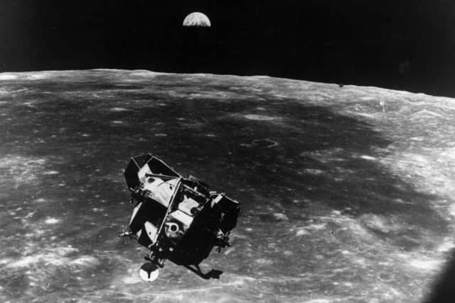 The Apollo 11 space module floating above the Moon. The Earth can be seen rising behind. (Photo by Keystone/Getty Images)