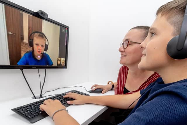 Louis and Oliver, on screen, having a go on Mable Therapy's online platform, with Lorraine Bamblett.