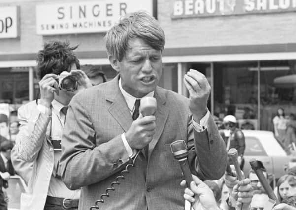Bobby Kennedy speaks to supporters as he campaigns standing up in an open convertible in Lafayette, Indiana, during the 1968 Indiana Presidential primary which he won handily. (Photo by Â© Wally McNamee/CORBIS/Corbis via Getty Images)