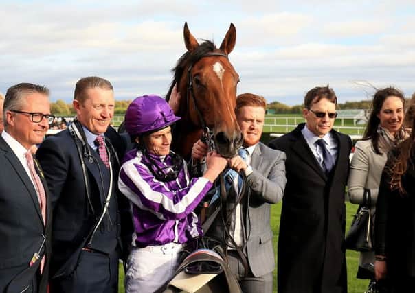 Jockey Ryan Moore (Third left) with trainer Aidan O'Brien (Second right) in the winners enclosure after winning the Racing Post Trophy at Doncaster last year.