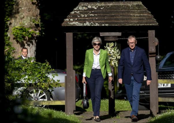 Prime Minister Theresa May and her husband Philip arrive for a church service near her Maidenhead constituency. This Friday marks the first anniversary of the election.