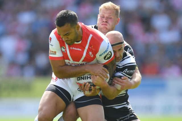 St Helens' Zeb Taia is tackled by Hull FC's Danny Houghton.