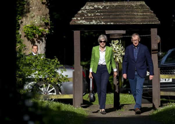 Prime Minister Theresa May and her husband Philip arrive for a church service near her Maidenhead constituency. This week marks the first anniversary of the election that saw Mrs May lose her Commons majority.