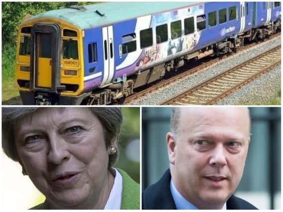 Theresa May has backed Transport Secretary Chris Grayling despite 'totally unacceptable' chaos suffered by Northern rail passengers.