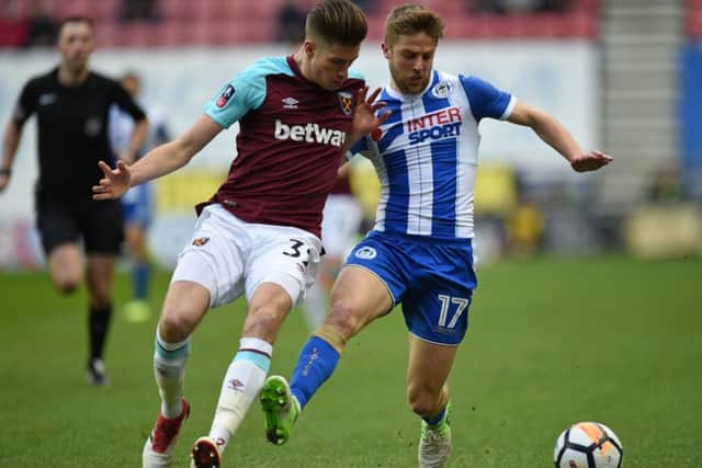 Wanted: West Ham United's Reece Burke, left. Picture: OLI SCARFF/AFP/Getty Images