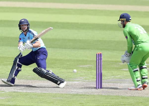 Yorkshire's Adam Lyth hits out from the bowling of  Lancashire's Matthew Parkinson watched by wicket keeper Dane Vilas..