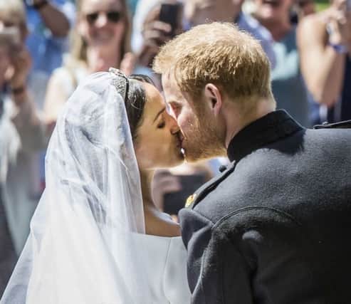 Meghan Markle and Prince Harry kiss on the steps of St George's Chapel at Windsor Castle following their wedding. Photo:  Danny Lawson/PA Wire