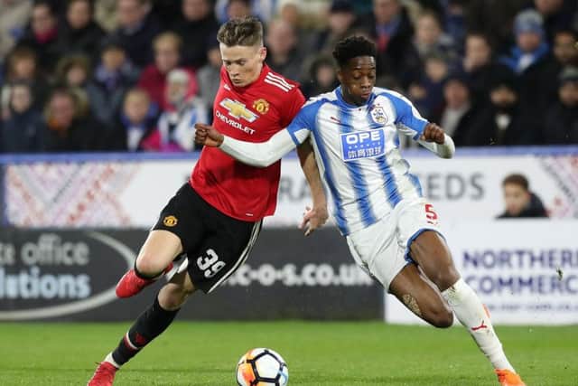 Manchester United's Scott McTominay (left) and Huddersfield Town's Terence Kongolo battle for the ball (Picture: PA)