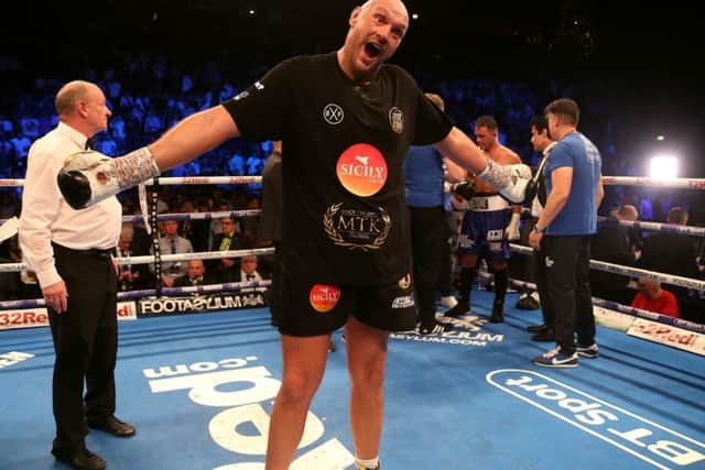 Tyson Fury (centre) celebrates beating Sefer Seferi at Manchester Arena. Picture: Nick Potts/PA Wire.