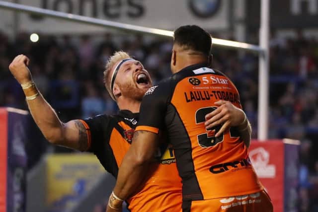 Oliver Holmes of Castleford Tigers celebrates scoring his side's fifth try with provider Quentin Laulu-Togagee. Picture: Paul Currie/SWpix.com