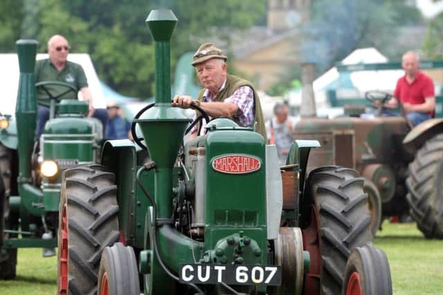 Field Marshall tractors parade at Tractor Fest at Newby Hall near Ripon.