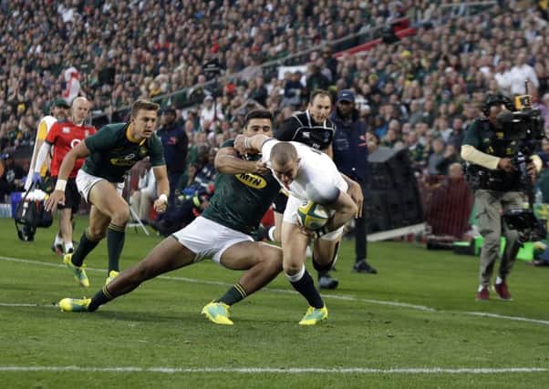 England's Mike Brown, right, avoids a tackle from South Africa's Jean-Luc du Preez to score an early try at Ellis Park. Picture: AP/Themba Hadebe