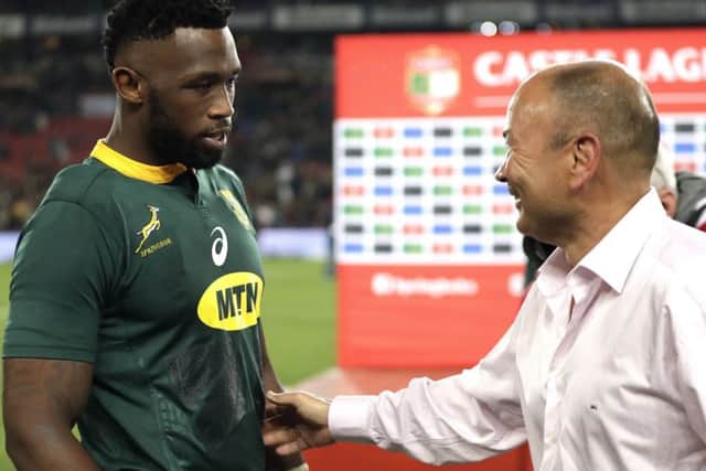 BIG DAY: South Africa's captain Siya Kolisi, left, is congratulated by England's coach Eddie Jones at Ellis Park. Picture: AP/Themba Hadebe.