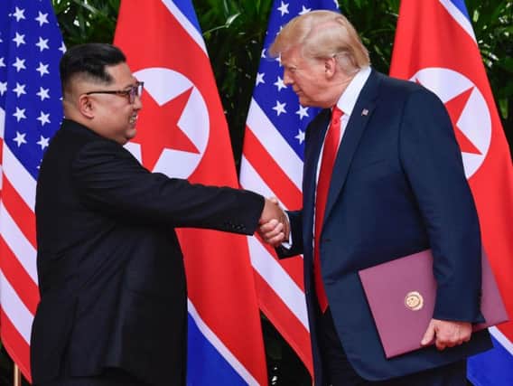 North Korea leader Kim Jong Un and U.S. President Donald Trump shake hands at the conclusion of their meetings at the Capella resort on Sentosa Island Tuesday, June 12, 2018 in Singapore. (AP Photo/Susan Walsh, Pool)