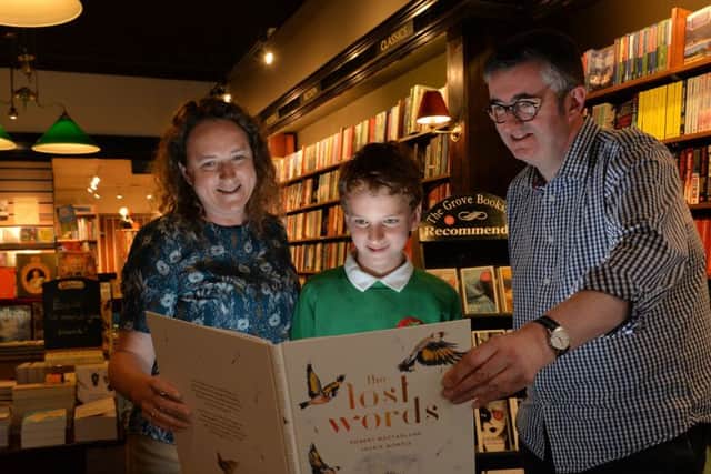 Vicky Cooke, her son Charlie Clerici, 10, and bookshop owner Mike Sansbury with 'The Lost Words' .