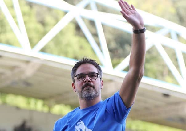 Terrier trademark: Huddersfield Town manager David Wagner with a T-shirt incorporating the new logo.
