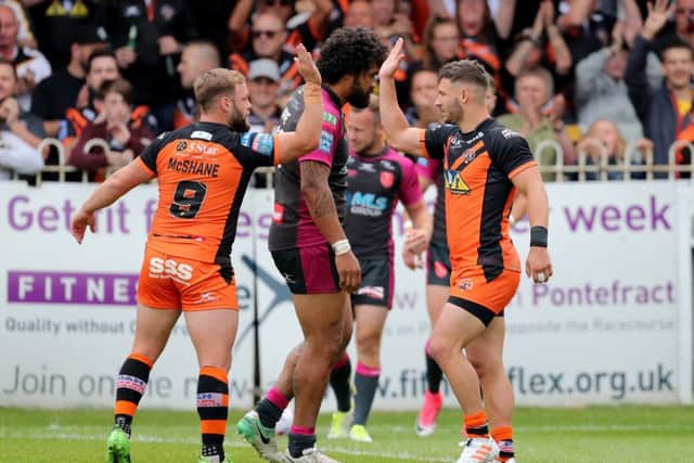 Castleford Tigers' Paul Mcshane congratulates Jy Hitchcox after scoring a try. Picture: Richard Sellers/PA