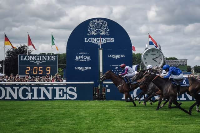 WINNER: Jockey PJ Mcdonald & Laurens, far left, cross the finish line to win the 169th edition of the Prix de Diane at Chantilly. Picture: LUCAS BARIOULET/AFP/Getty Images.