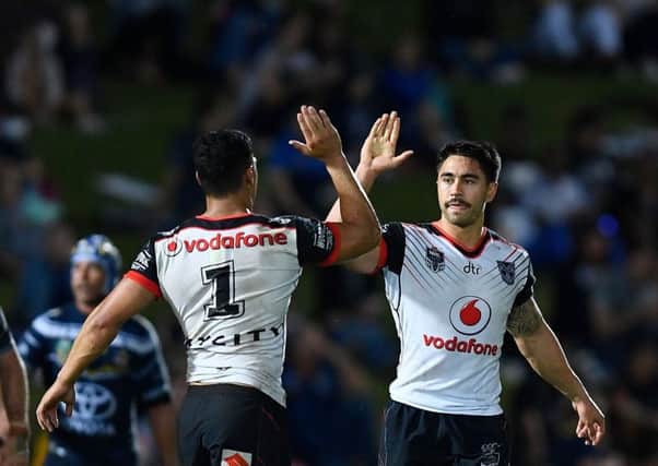 STAR TURN: New Zealand Warriors' Shaun Johnson celebrates with Roger Tuivasa-Sheck after kicking a goal  against North Queensland Cowboys. Picture: Ian Hitchcock/Getty Images.