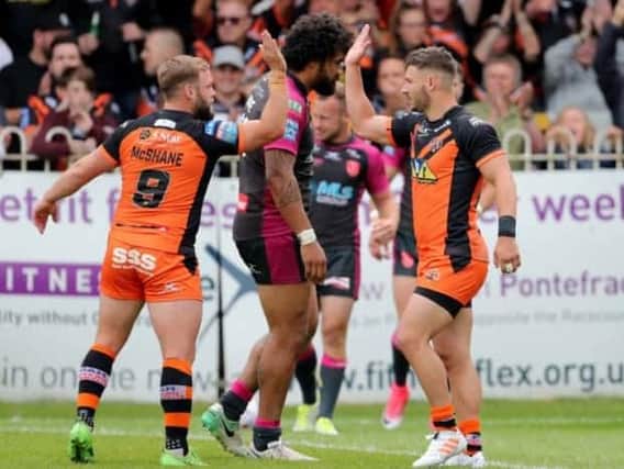 Castleford Tigers' Jy Hitchcox, right, celebrates one of his four tries against Hull KR with team-mate Paul McShane.