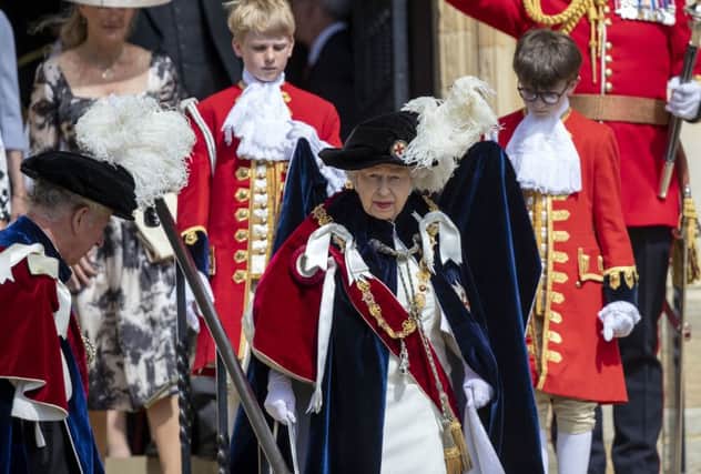 The Queen leaves St George's Chapel, in Windsor Castle, after attending the annual Order of the Garter Service.