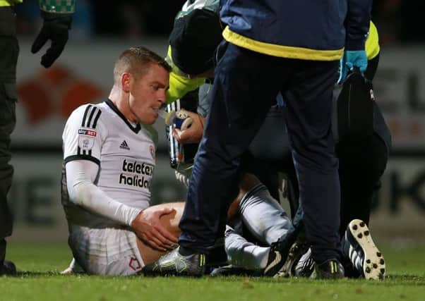 Paul Coutts receives oxygen after breaking his leg at Burton last season (Picture: Simon Bellis/Sportimage)