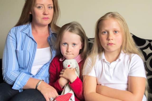 Janet Alexander with her daughters Rose and Lois, who is suing holiday company Thomas Cook after claiming her daughter was abducted from a hotel kids club in Turkey. Image: Digby Brown