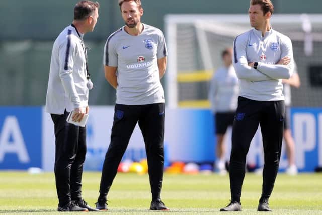 England manager Gareth Southgate with, left, assistant Steve Holland and striker coach Allan Russell, right, during a training session at Spartak Zelenogorsk Stadium on Wednesday. Picture: Owen Humphreys/PA