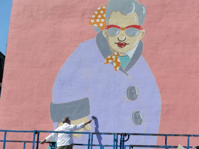Sheffield artist Pete McKee works on 'Muriel' a new mural on the side of the Art House on Carver Street.