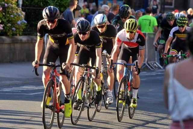 Triathlete Jonny Brownlee (yellow helmet)  takes part in the Ilkley Cycle Races mens 3rd and 4th category taking place in glorious sunshine in the centre of the town.  Picture Tony Johnson.