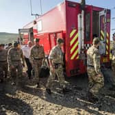 Soldiers from the Royal Regiment of Scotland arrive on Saddleworth Moor near Manchester where they will help fight a vast moorland blaze which has been alight for several days.