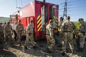Soldiers from the Royal Regiment of Scotland arrive on Saddleworth Moor near Manchester where they will help fight a vast moorland blaze which has been alight for several days.