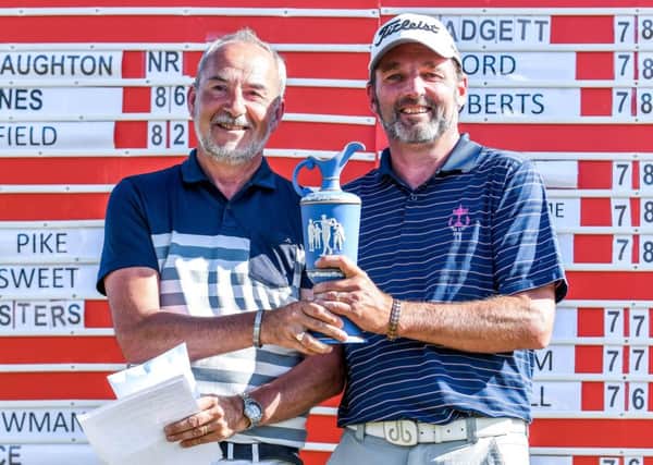 Nigel Sweet, Operations Manager at Leeds Golf Centre, hands the Leeds Senior Masters trophy to winner David Shacklady (Picture: George Wood Photography).
