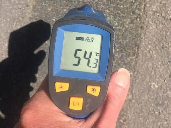 Rowen used an infrared thermometer to show residents just how hot the ground is at the moment.