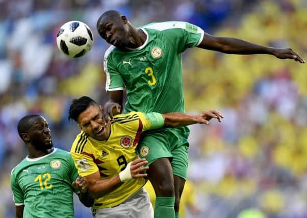 Colombia's Radamel Falcao, centre, jumps for the ball with Senegal's Kalidou Koulibaly, right, and Youssouf Sabaly during their group H match in Samara (Picture: Martin Meissner/AP).