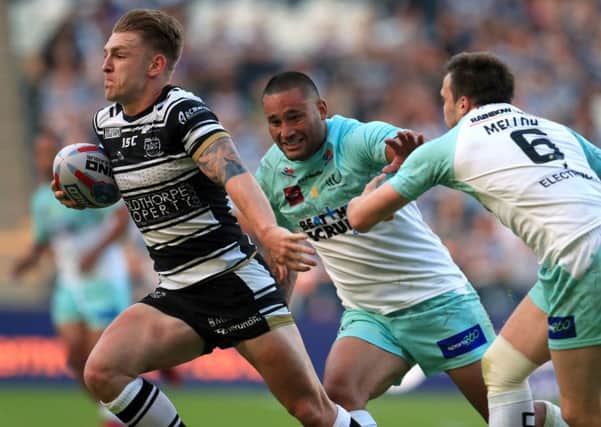 Hull FC's Liam Harris (left) breaks through to score a try past Widnes Vikings' Joe Mellor (right).
