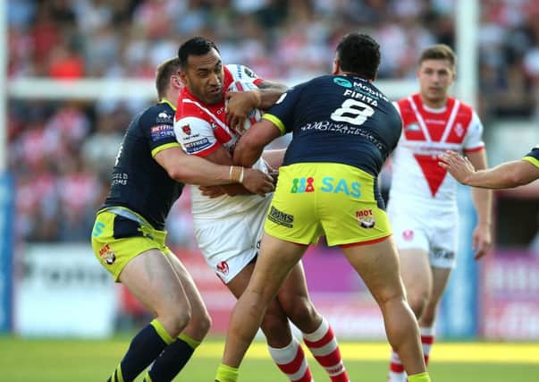 St Helens Zeb Taia is tackled by Wakefield Trinity's David Fifita (right) and James Batchelor (left).